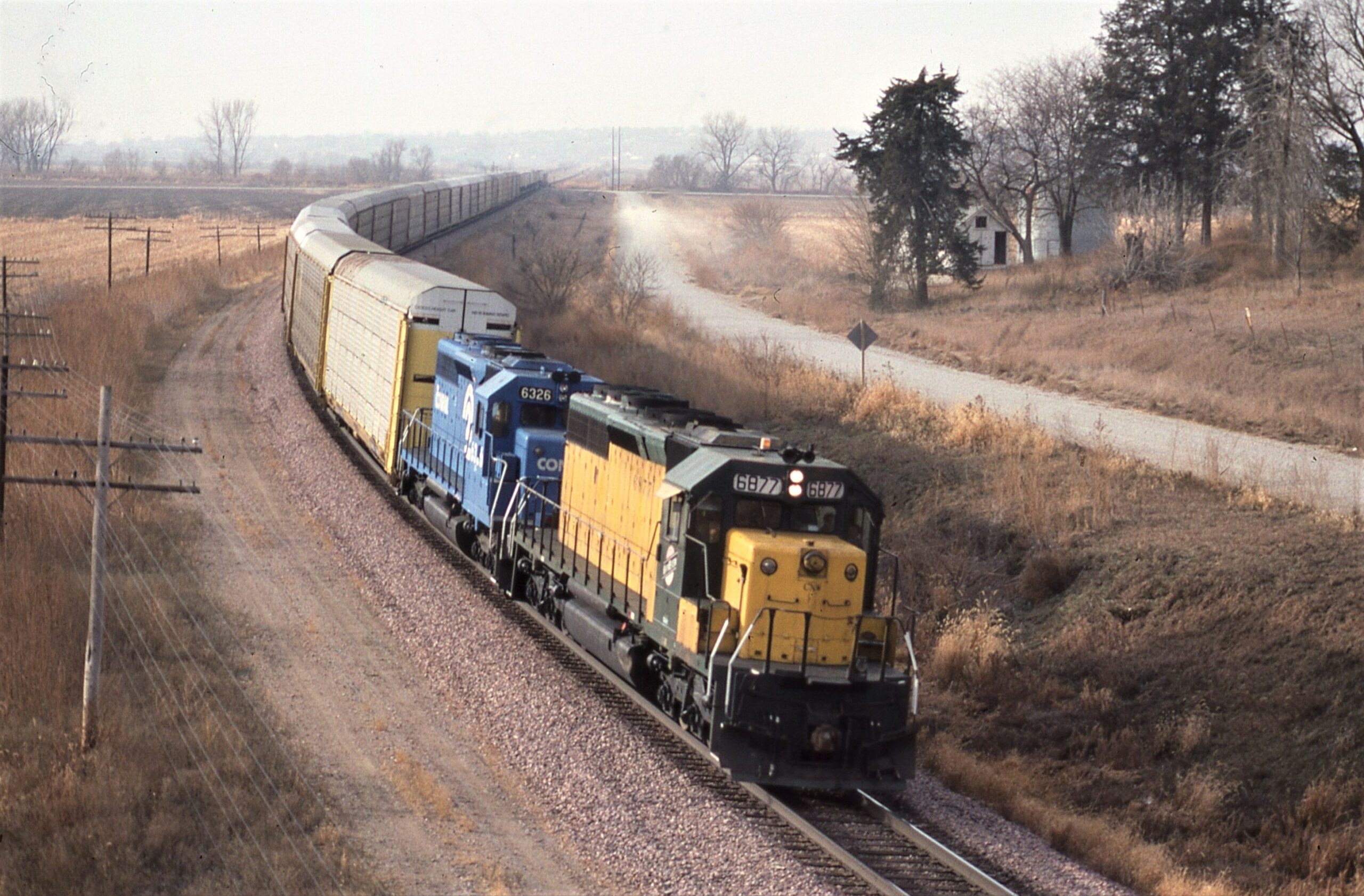 Chicago and Northwestern | Logan, Iowa | SD40-2 6877 | Conrail SD40-2 6326 | East bound Auto Rack Train | December 9, 1984 | Dave Zeutschel
