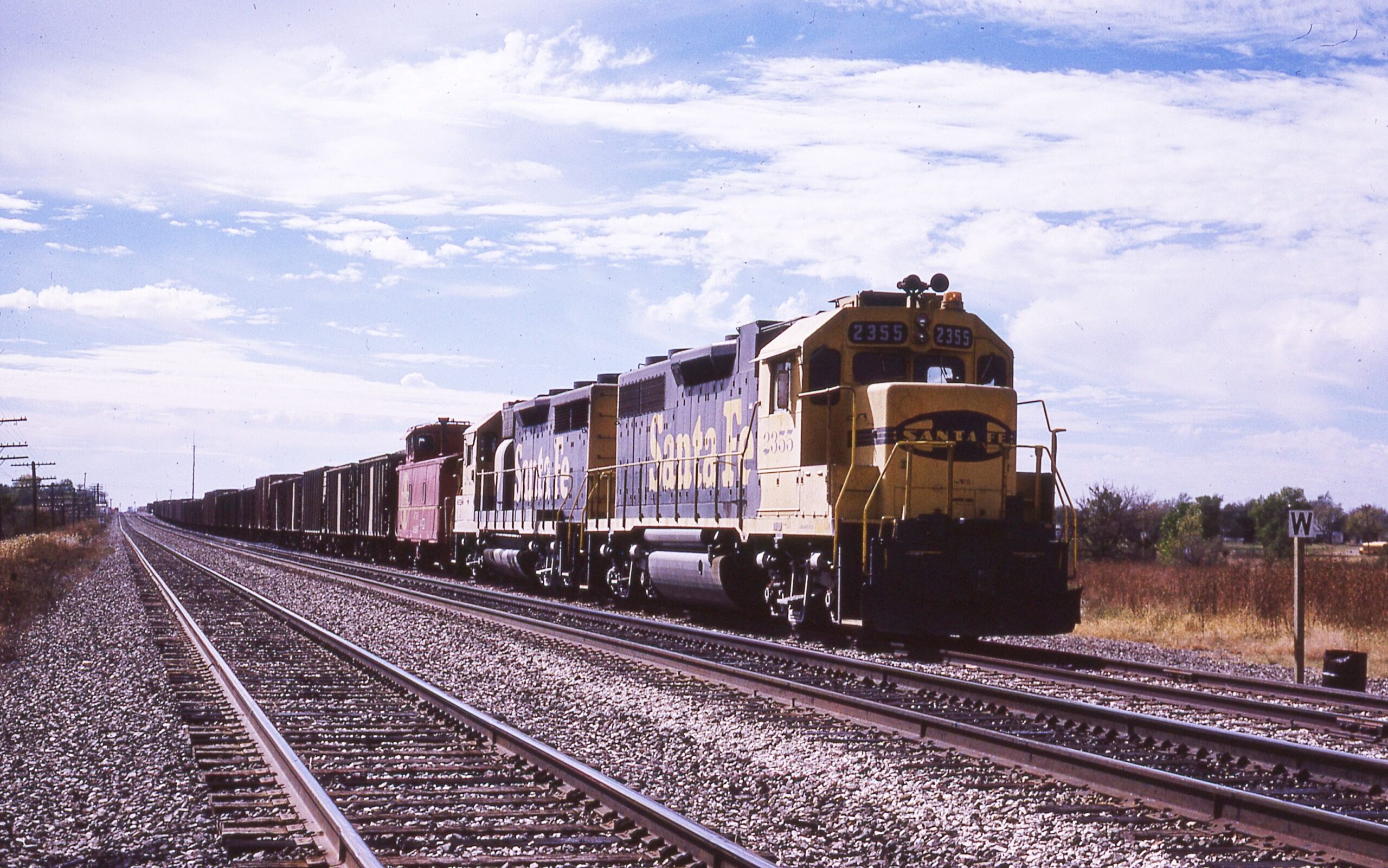 Atchison Topeka and Santa Fe Railway | Cassoday, Kansas | EMD Diesel-electric locomotive GP38u #2355 + 1 | Hopper train | October 21,1989 | Dave Rector Photo