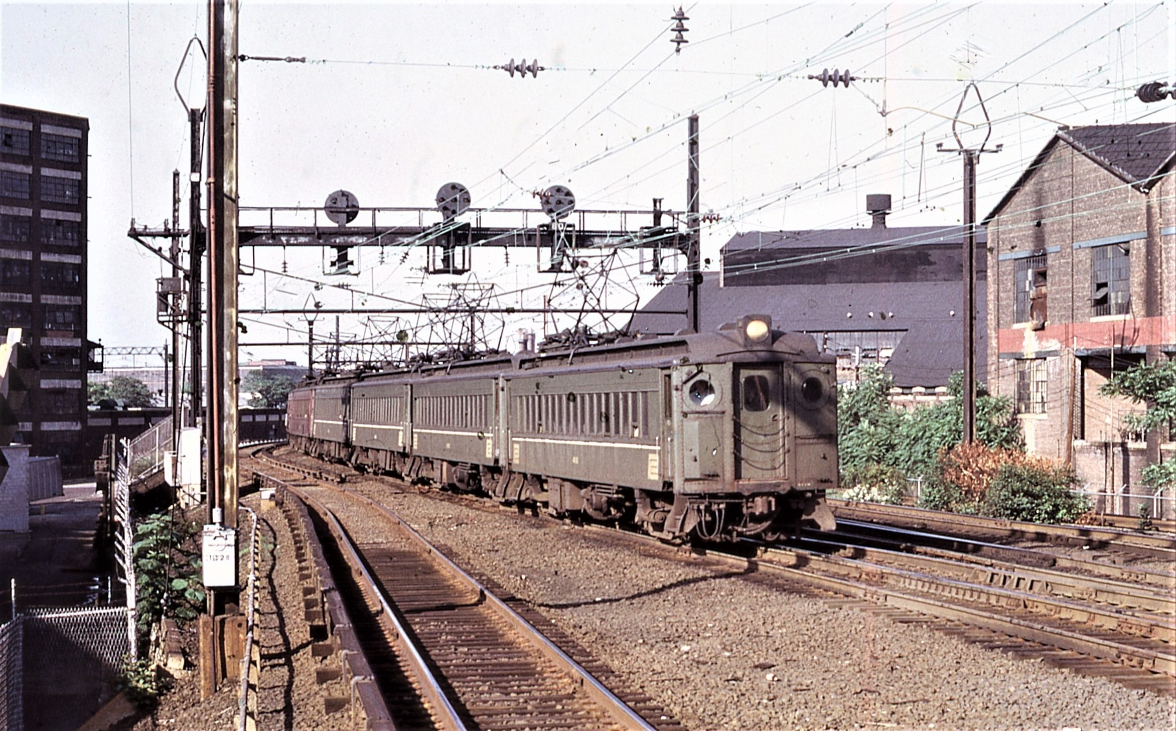 Penn Central Transportation Company | Harrison, New Jersey | MP54 #411 plus train | July 1974 | William Rosenberg photograph