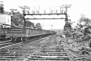 New York Westchester and Boston | Mount Vernon, New York | Willson’s Woods right-of-way | Gondola cars | Signal bridge | May 1942 | Fielding Lew Bowman photograph