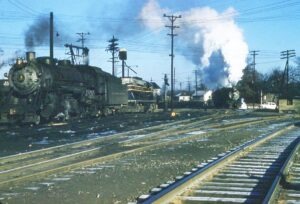 Baltimore and Ohio | North Vernon, Indiana | Q3 class 2-8-2 #329, EMD GP9 #3421 diesel, Q3 class 2-8-2 #385 steam locomotives | January 1,1958 | Frank Kozempel photograph