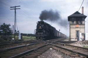 Nickel Plate Road | Pennsylvania Railroad | Burnham, Indiana | Class 2-8-4 #769 steam locomotive | freight train | Burnham Tower | July 1954 | Robert Mehlenbeck photograph | Morning Sun Books collection