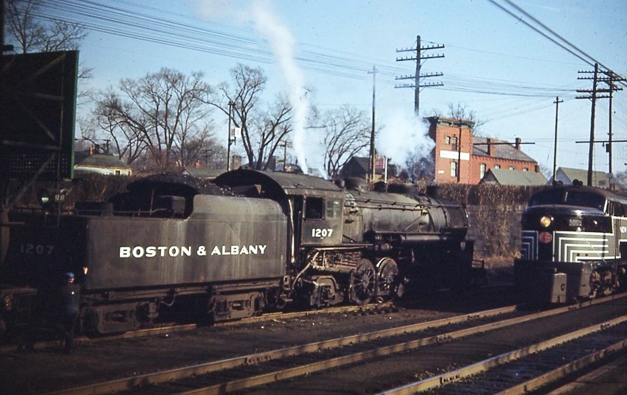 Boston and Albany | New York Central | Palmer, Massachusetts | Class H5 2-8-2 #1207 steam locomotive and FM Erie Bult C-liner diesel electric locomotives | freight passing | December 17, 1949 | William J. McChessney photograph | Morning Sun Books collection
