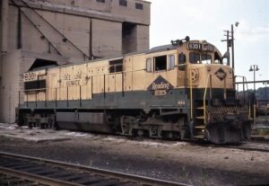 Reading Company | Rutherford, Pennsylvania | Class GE U30C #6301 diesel-electric locomotive and passenger train | at defunct coaling tower | August 11,1970 | Dick Flock photograph