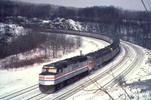 Amtrak | Altoona, Pennsylvania | Benny’s curve | EMD F40PH-2 #312 + E8a and E8b diesel-electric locomotives | Broadway Ltd. eastbound | January 1973 | unknown photographer