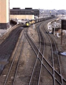 Chicago and Northwestern | Saint Paul, Minnesota | EMD SD60 #8011 and UP GE D8-40CW #9352 diesel-electric locomotive | empty coal hoppers | March 21, 1993 | Dick Flock photograph