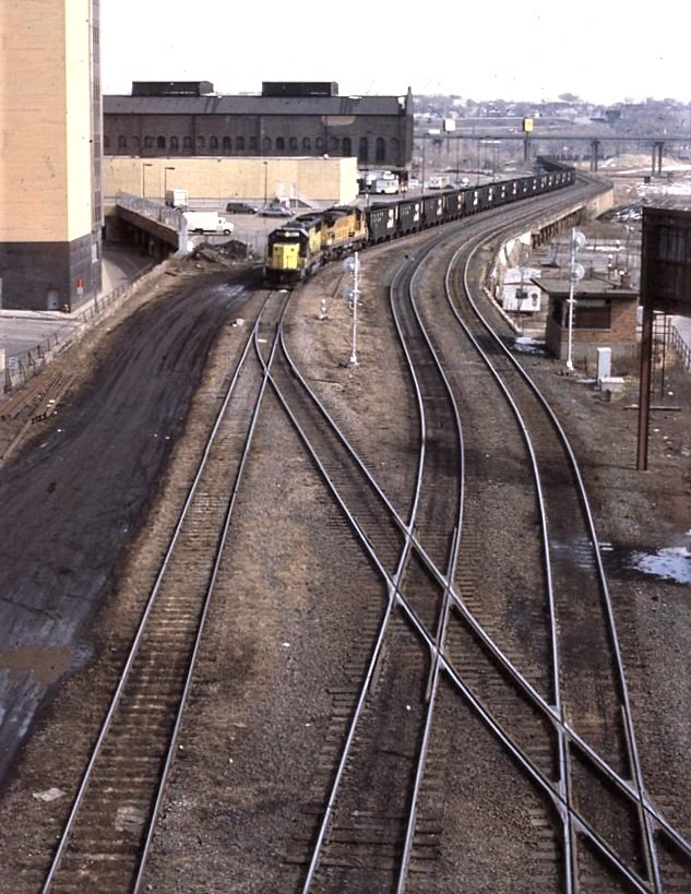 Chicago and Northwestern | Saint Paul, Minnesota | EMD SD60 #8011 and UP GE D8-40CW #9352 diesel-electric locomotive | empty coal hoppers | March 21, 1993 | Dick Flock photograph