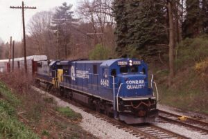 Conrail | Bakerstown, Pennsylvania | GE C36-7 #6642 and CSX ED SD50 #8584 diesel-electric locomotives | Auto racks | 8: 37 AM | April 27, 1995 | Dick Flock photograph