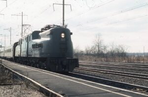 Penn Central Transportation Company | Amtrak | Edison, New Jersey | Altoona Works class GG1 #4937 motor | eastbound passenger train | February 1976 | Jack de Rosset photograph | Morning Sun Books collection