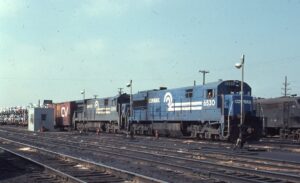 Conrail | Cleveland, Ohio | GE U28C #6530 + U36C #6596 diesel-electric locomotives | on freight train with autoracks | March 1977 | David Hamley photograph | Mitchell E. Dakelman collection