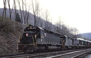 Pennsylvania Railroad | Renovo, Pennsylvania | EMD SD45 #6113, GP35 #2243 + GP9b diesel-electric locomotives | Auto rack train | April 23, 1967 | Richard R. Wallin photograph | Richard Prince Collection