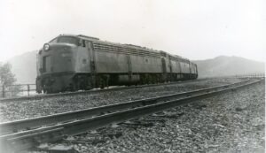 Amtrak | on Penn Central Transportation | Rockville, Pennsylvania | EMD E8a#323 + 2 diesel-electric locomotives | eastbound National Limited | June 1974 | Ed Kaspriske photograph / collection