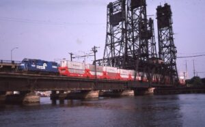 Conrail | Kearny, New Jersey  EMD GP38-2 #8010 diesel-electric locomotive | Double stack train | on Hackensack River Bridge | July 1985 | Frank Etzel photograph / collection
