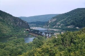 Baltimore and Ohio Railroad | Harpers Ferry, West Virginia | General view with passenger train on Potomac River Bridge | August 1956 | Henry Libby photograph / collection