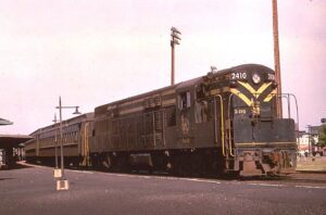 Central Railroad of New Jersey | Elizabethport, New Jersey | FM H24-66 #2410 diesel-electric locomotive | Elizabethport Station | Bay Head bound passenger train | June 1965 | Dave Sweetland photograph | Richard Prince collection
