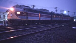Erie Lackawanna Railway | Suffern, New York | EMD E8a #820, F7 7103, E8a 827 diesel-electric locomotives and caboose C261 | night photo | August 24, 1974 | Sandy Burton photograph | Jersey Central Chapter NRHS collection