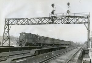 Central Railroad of New Jersey | Westfield, New Jersey | EMD Class GP7P #1529 diesel-electric locomotive | Commuter passenger train passing under signal bridge | April 1970 | Ed Kaspriske photograph / collection