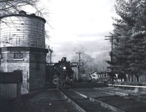 New York Central System | Dunwoodie, New York | Class 4-6-0 #1234 steam locomotive | at station and water tower | Putnam Branch commuter train | February 1951 | Fielding Lew Bowmanb