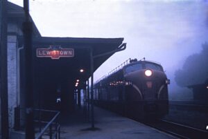 Pennsylvania Railroad | Lewistown, Pennsylvania | Class E8a #5874 diesel-electric locomotive | Westbound passenger train | Lewistown Station | August 1962 | Richard R. Wallin photograph u