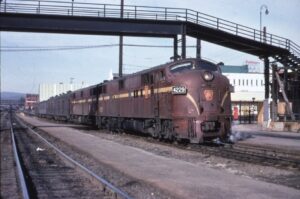 Penn Central Transportation Company | ex Pennsylvania Railroad | Altoona, Pennsylvania | EMD E7a 4229 + E7b diesel-electric locomotive | Mail and passenger train | Foot bridge | May 1968 | Gerald H. Landau photograph | Mitchell E. Dakelman collection