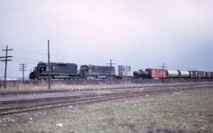 Pennsylvania Railroad | Detroit, Michigan | EMD SD35 #60xx and GE U30C #6536 diesel-electric locomotives | on a freight | April 1966 | Emery Gulash photograph | Stephen Timko collection
