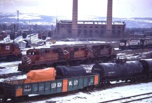 Lehigh Valley Railroad | Buffalo, New York | Alco RS11 #400 + 2 and C628 diesel-electric locomotives | Gondola car #37094 with orange striping | Shop Building and Yards | December 23, 1974 | Warren Beckwith, Jr. photograph / collection