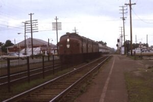 Penn Central Transportation Company | on New York and Long Branch | Little Silver, New Jersey | EMD E8a #4298 diesel-electric locomotive | with commuter train | August 1970 | Ken Kulick photograph / collection
