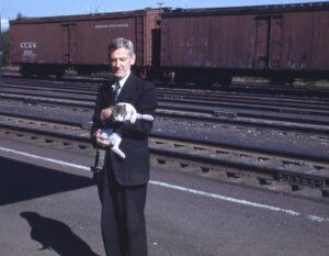 Delaware, Lackawanna and Western Railroad | Tobyhanna, Pennsylvania | Tobyhanna Station Agent Patrick J. Scanlon with cat | September 1948 | Henry Libby photograph / collection