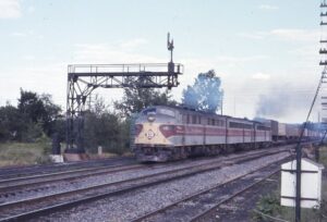 Erie Lackawanna Railway | Johnson City, New York | EMD E8a #822, #827 and #826 diesel-electric locomotives | Semaphore signal tower | Westbound PB99 TV train | July 21,1974 | Charles “Sandy” Burton photograph | Jersey Central Chapter, NRHS collection