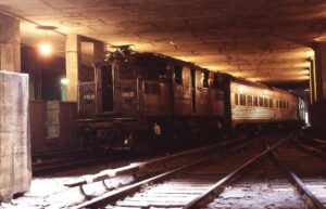 New York Central System | New York, New York | GE S2 #102 electric-motor | with passenger train | Interior Grand Central Station | July 1976 | Al Roberts photograph | Mitchell E. Dakelman collection