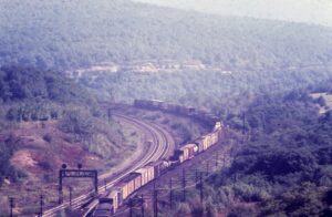 Penn Central Transportation Company | Pennsylvania Railroad | Gallitzin, Pennsylvania | Eastbound freight exiting New Portage Tunnel | October 1968 | Ken Kulick photograph / collection